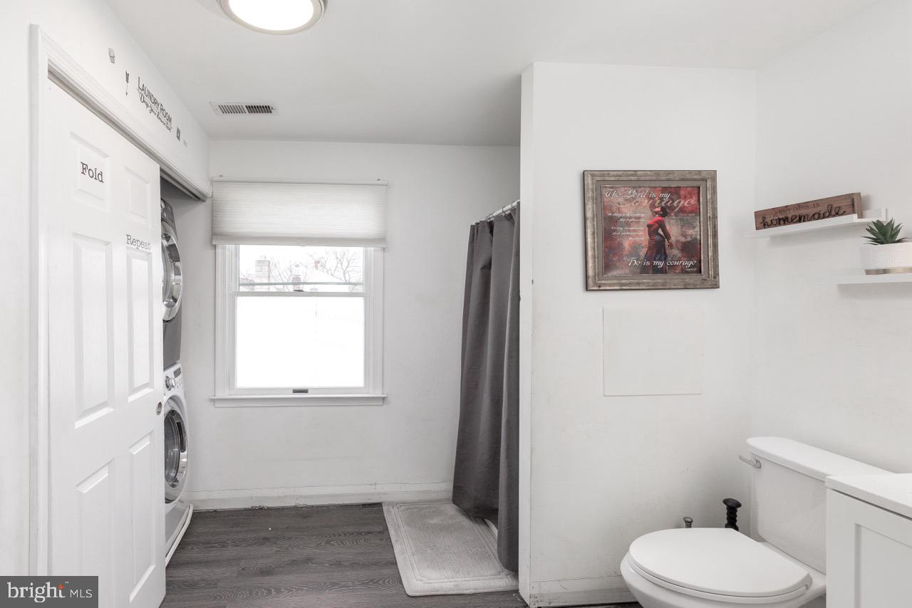 812 Silver Avenue Baltimore, MD 21221 - Photo 19 of 21 a white toilet sitting next to a bathroom sink and tub
