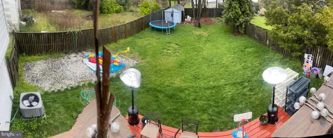 a backyard of a house with lots of green space and plants
