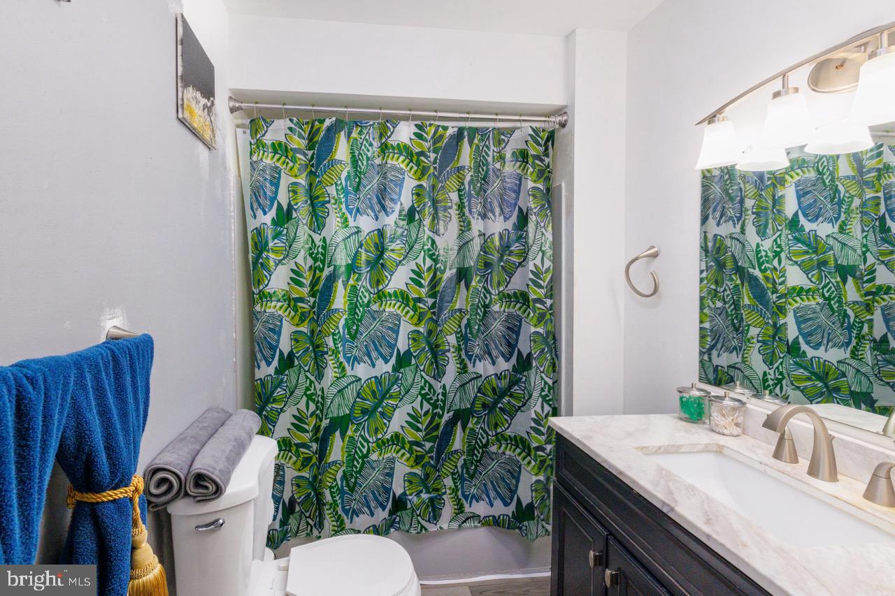 812 Silver Avenue Baltimore, MD 21221 - Photo 8 of 21 a bathroom with a sink and mirror