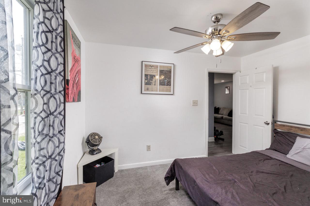 812 Silver Avenue Baltimore, MD 21221 - Photo 9 of 21 a bedroom with a bed and a chandelier