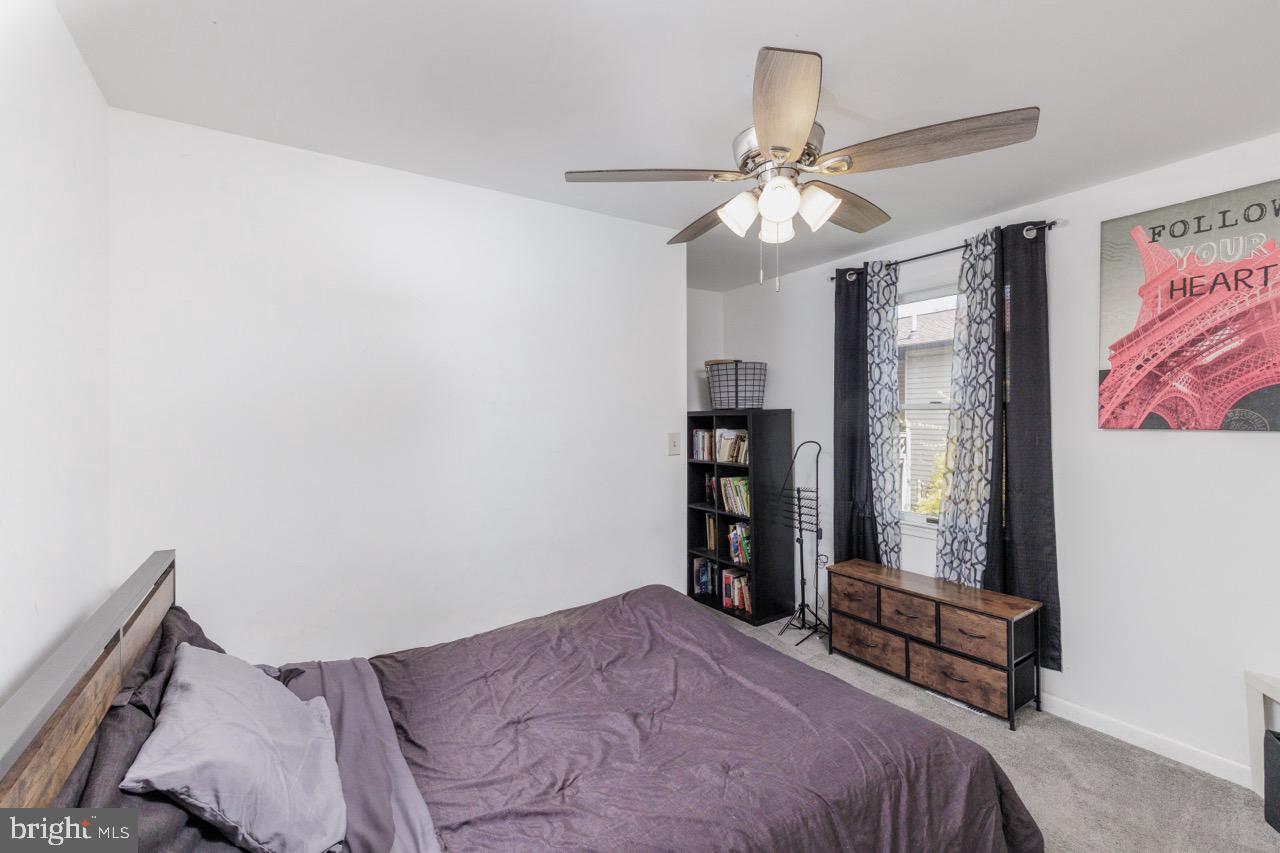 812 Silver Avenue Baltimore, MD 21221 - Photo 10 of 21 a bedroom with a bed and a chandelier