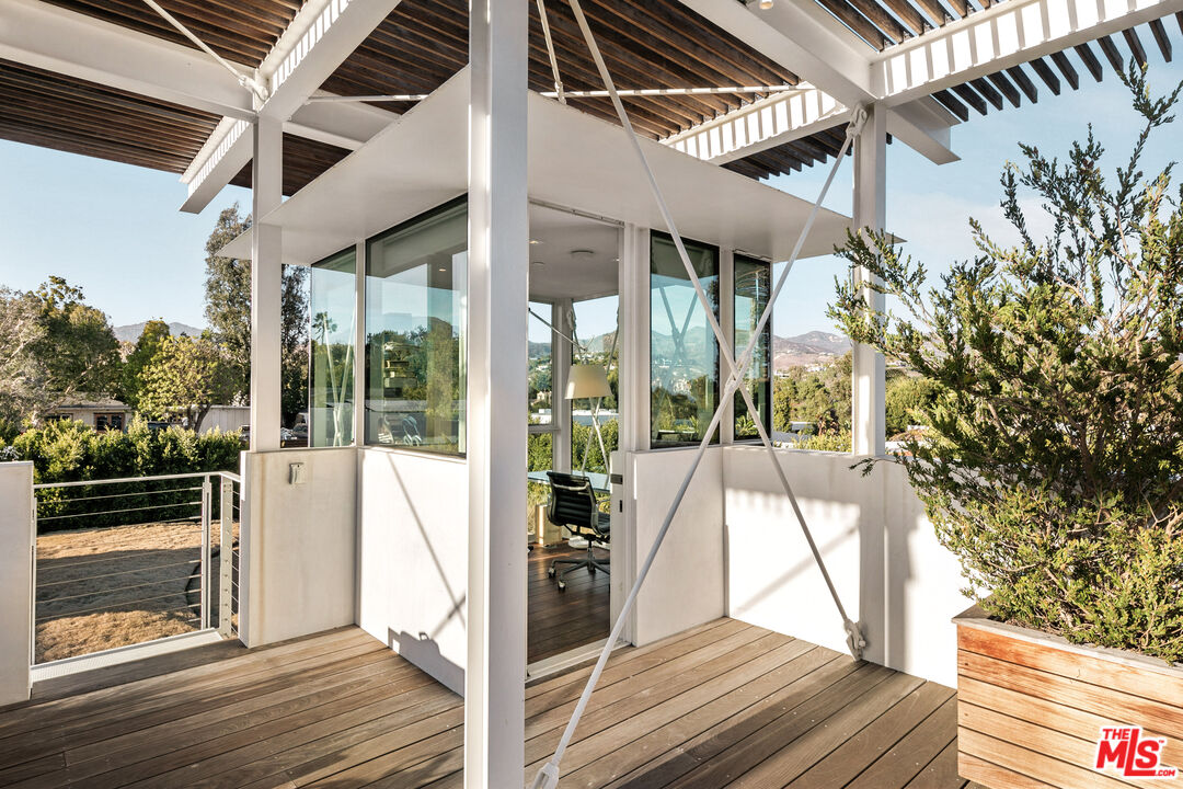 6728 Wildlife Road Malibu, CA 90265 - Photo 38 of 57 a view of balcony with wooden floor and door
