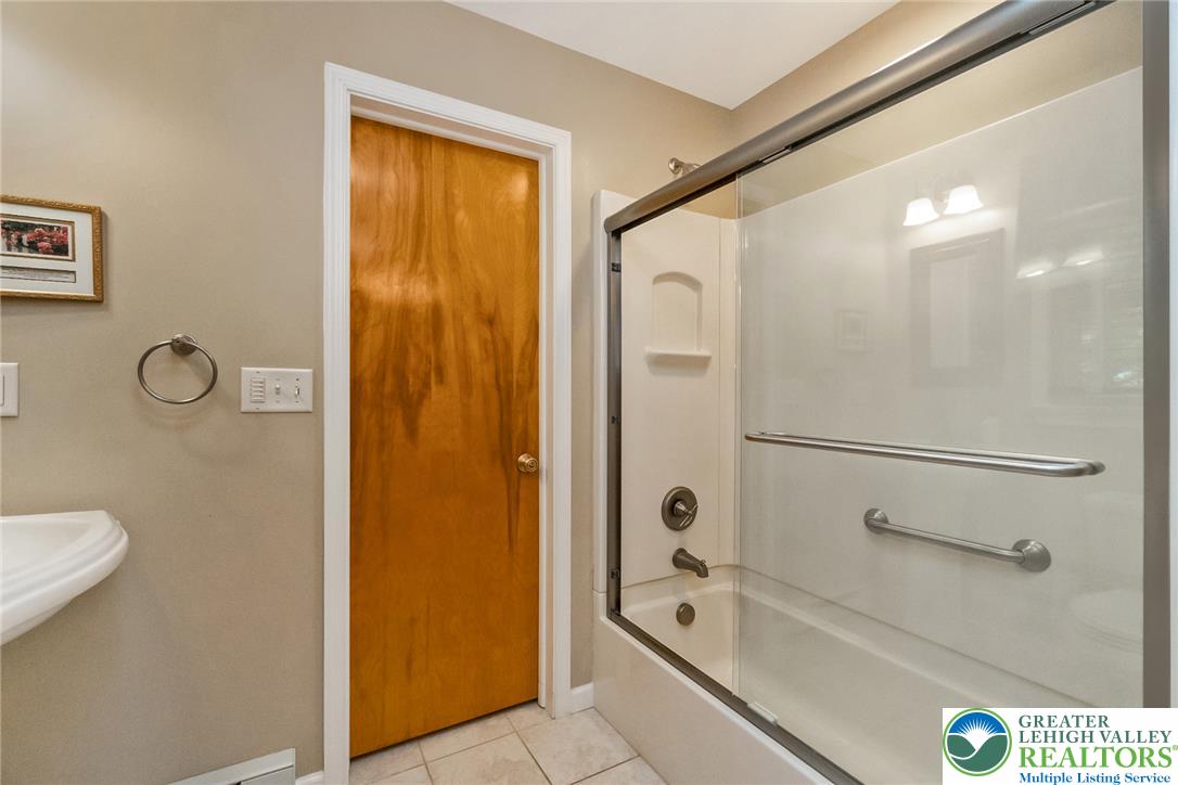 1328 Russett Road Allentown, PA 18104 - Photo 32 of 46 A well-appointed bathroom with a pristine tub and shower combination, featuring convenient grab bars.