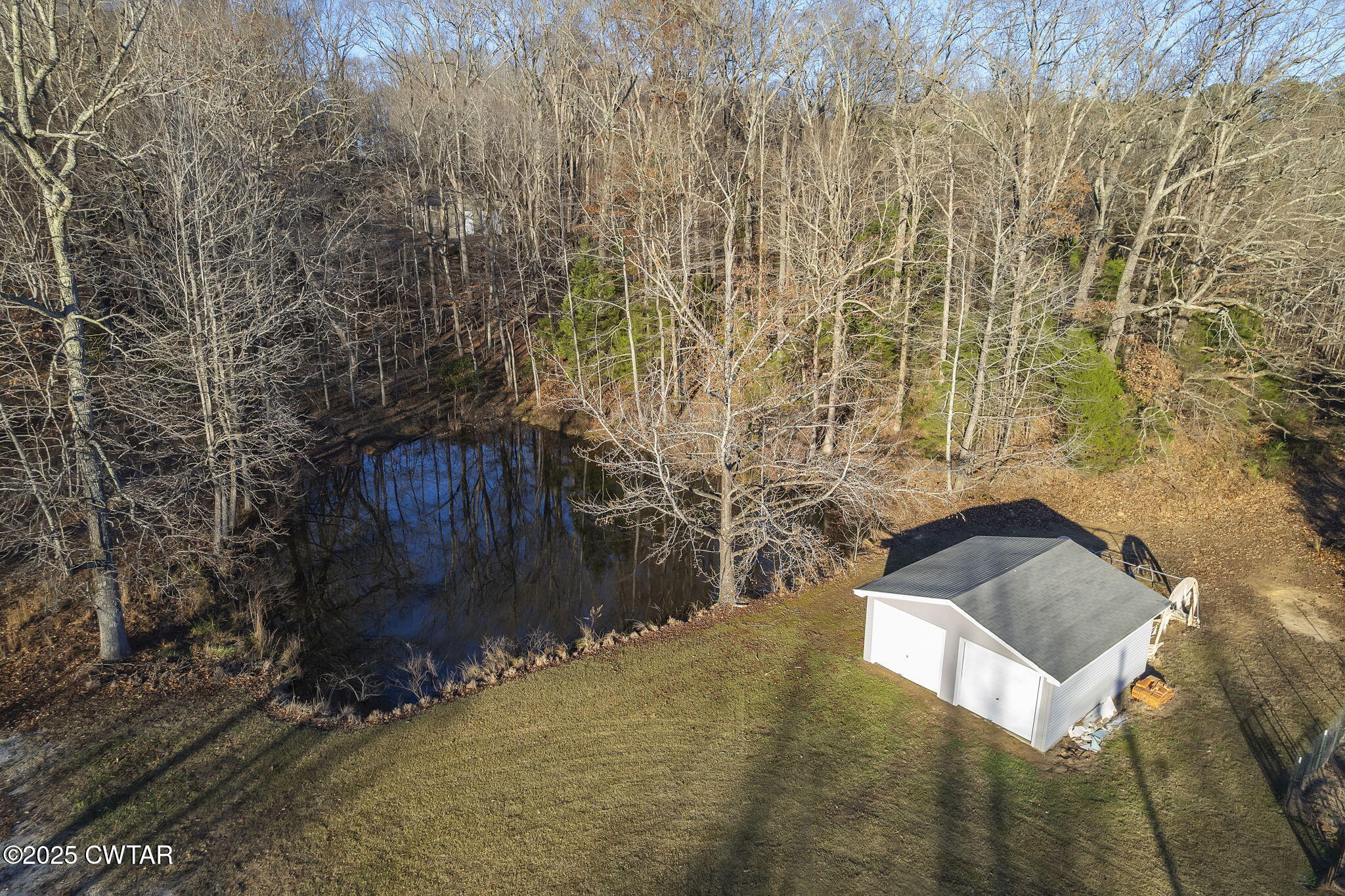 527 John Brown Road Beech Bluff, TN 38313 - Photo 2 of 28 a bench sitting in middle of a forest