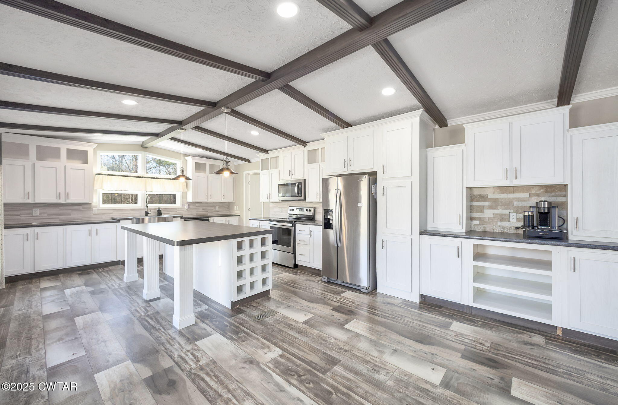 527 John Brown Road Beech Bluff, TN 38313 - Photo 8 of 28 a kitchen with white cabinets and stainless steel appliances
