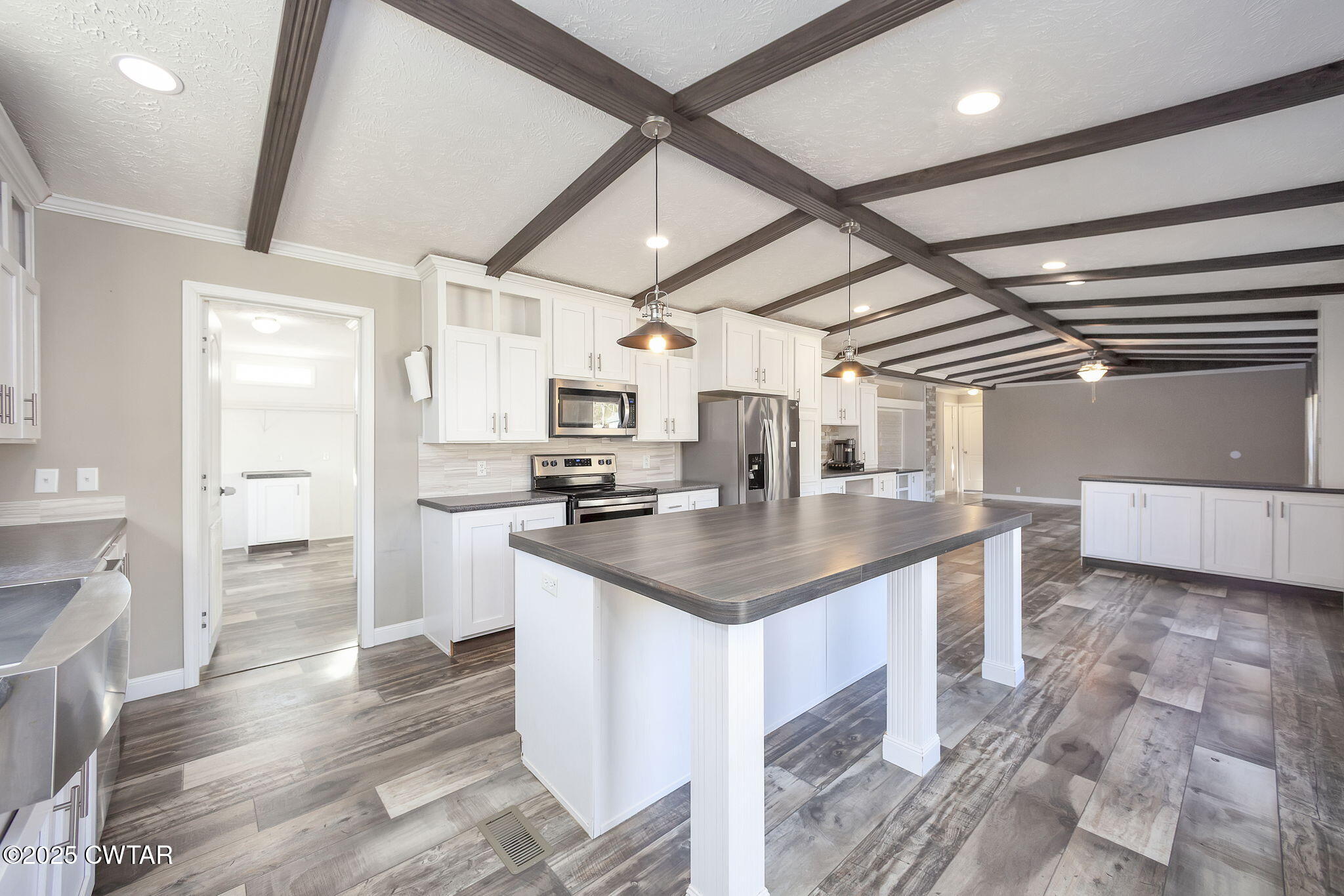 527 John Brown Road Beech Bluff, TN 38313 - Photo 10 of 28 a kitchen with stainless steel appliances a sink a stove a refrigerator cabinets and a dining table