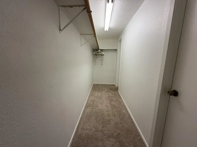 a spacious bathroom with a tub sink and mirror