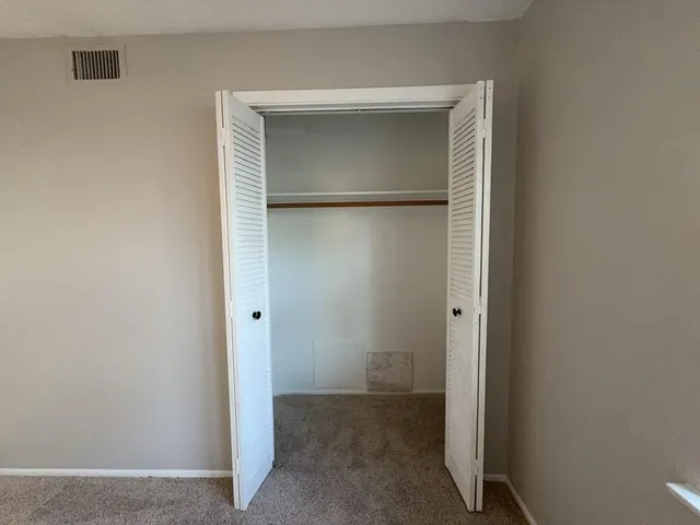 an empty room that has a window in it