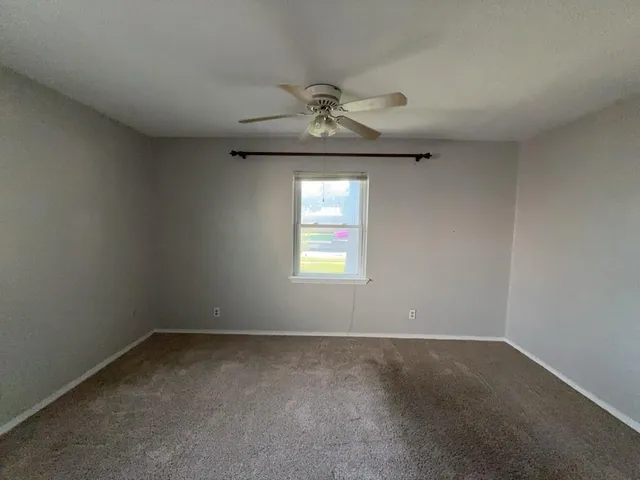 an empty room with a empty space and windows