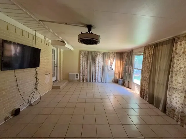 an empty room with windows and entrance