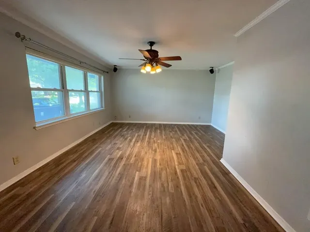 wooden floor in an empty room with a window