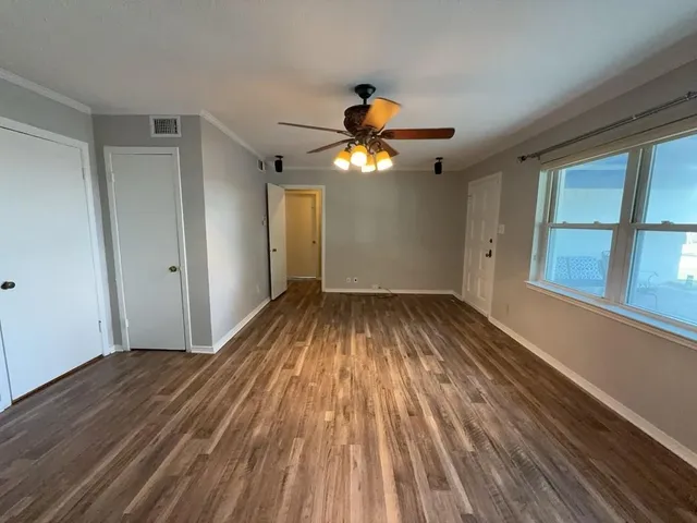 wooden floor in an empty room with a window