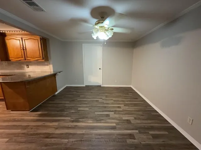 a view of a kitchen with a sink and cabinets