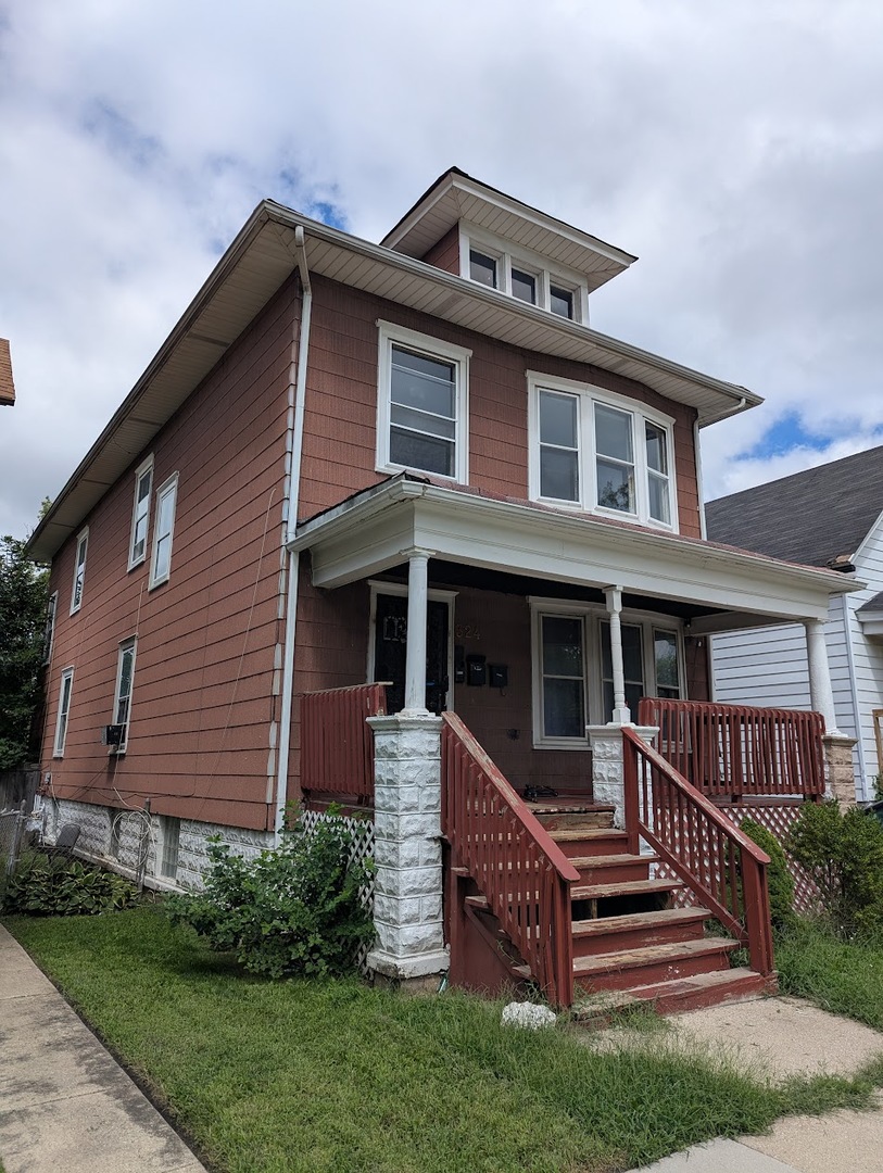 324 West 112th Street Chicago, IL 60628 - Photo 2 of 17 a front view of a house with a yard