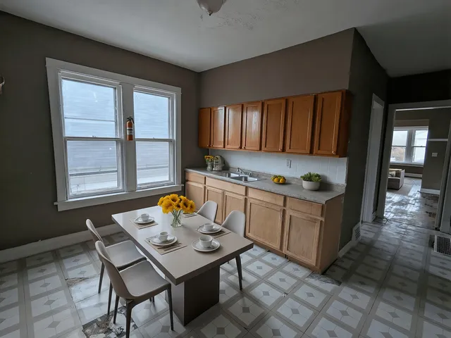 a kitchen with a sink cabinets and window