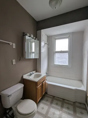 a bathroom with a sink a toilet and mirror