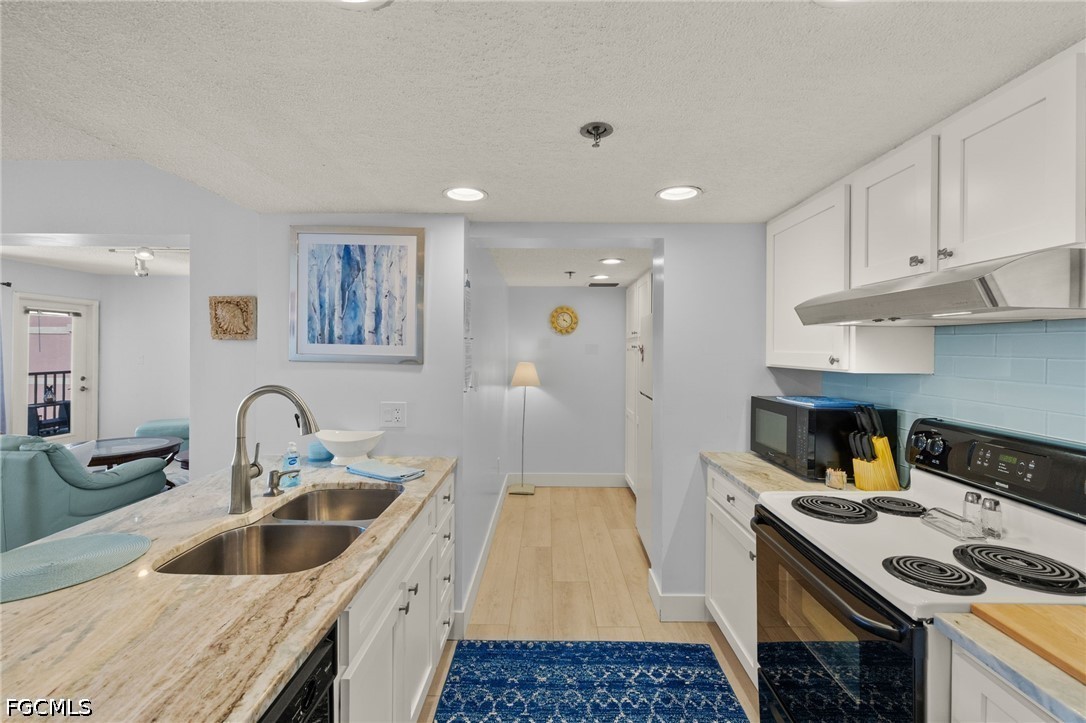 3170 Matecumbe Key Road, Unit 134 Punta Gorda, FL 33955 - Photo 11 of 31 a kitchen with a sink stove and refrigerator