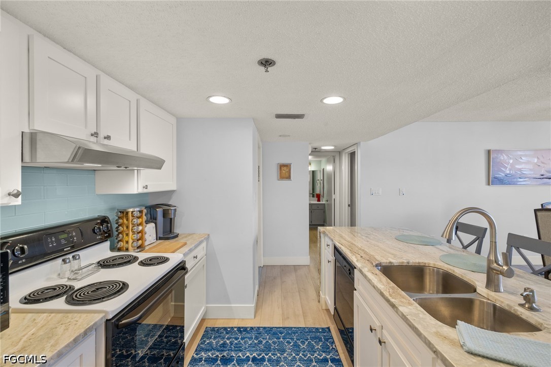 3170 Matecumbe Key Road, Unit 134 Punta Gorda, FL 33955 - Photo 12 of 31 a kitchen with a sink stove and refrigerator
