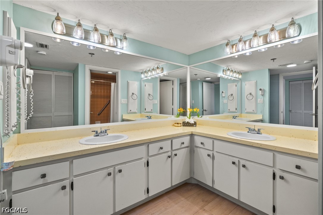 3170 Matecumbe Key Road, Unit 134 Punta Gorda, FL 33955 - Photo 18 of 31 a spacious bathroom with a double vanity sink and a mirror