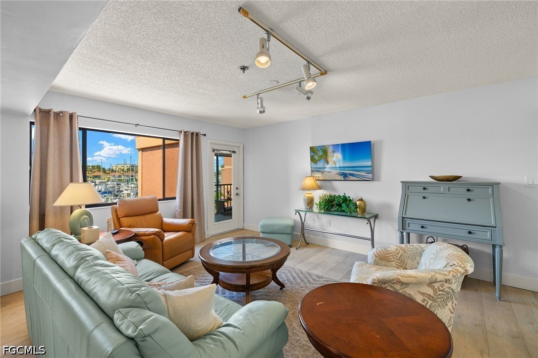 3170 Matecumbe Key Road, Unit 134 Punta Gorda, FL 33955 - Photo 2 of 31 a living room with furniture and a large window