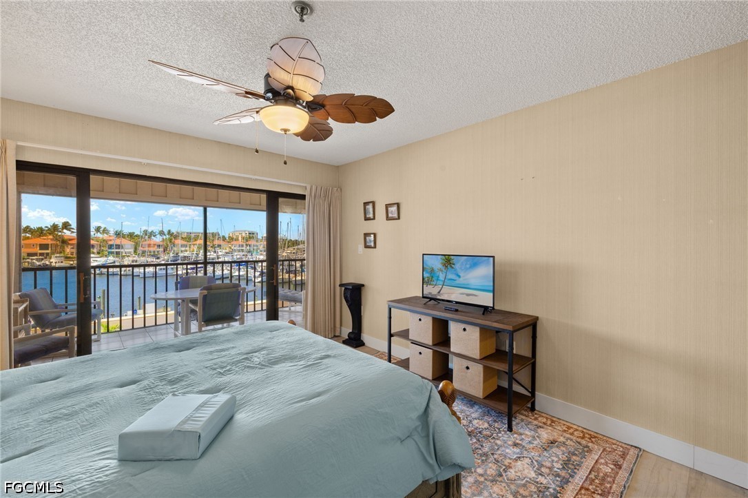 3170 Matecumbe Key Road, Unit 134 Punta Gorda, FL 33955 - Photo 23 of 31 a bedroom with a large bed and a chandelier