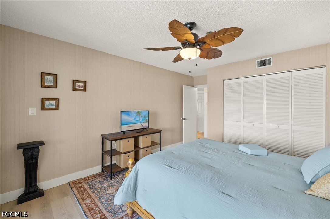 3170 Matecumbe Key Road, Unit 134 Punta Gorda, FL 33955 - Photo 24 of 31 a bedroom with a bed and a chandelier