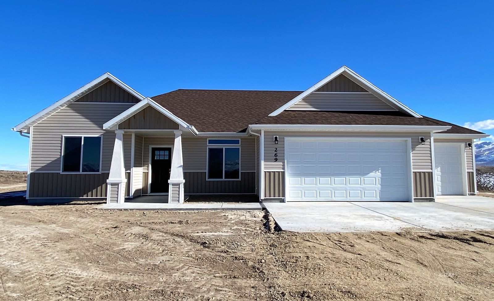 269 Sun Vly Road Spring Creek, NV 89815 - Photo 1 of 25 a front view of a house with a yard and garage