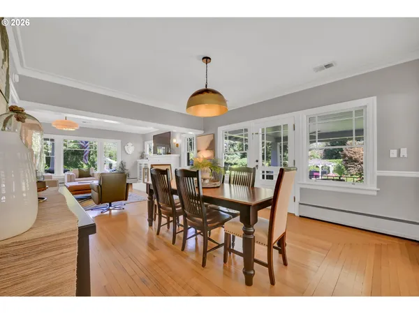 a dining room with furniture window and wooden floor