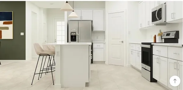 a kitchen with stainless steel appliances a refrigerator and a stove top oven