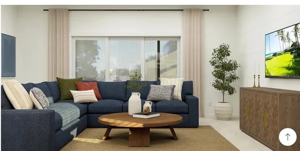 a living room with furniture and a potted plant