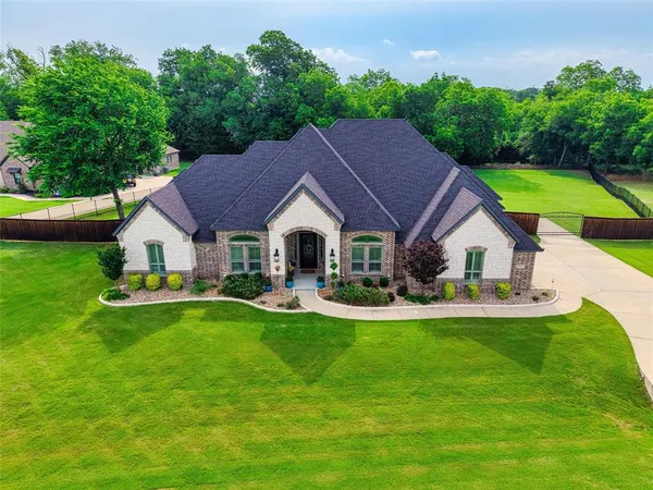 a front view of house with yard and outdoor seating