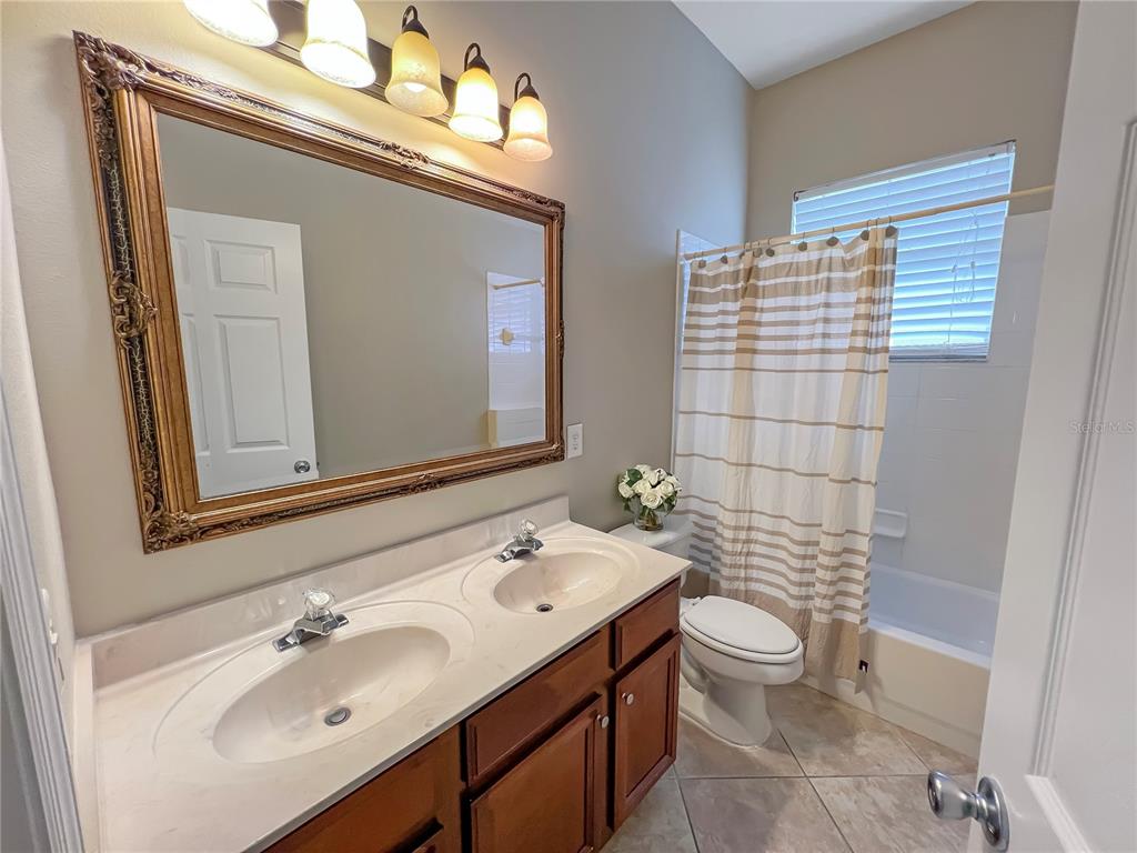 11531 Vicolo Loop Windermere, FL 34786 - Photo 13 of 32 a bathroom with a sink a toilet and mirror