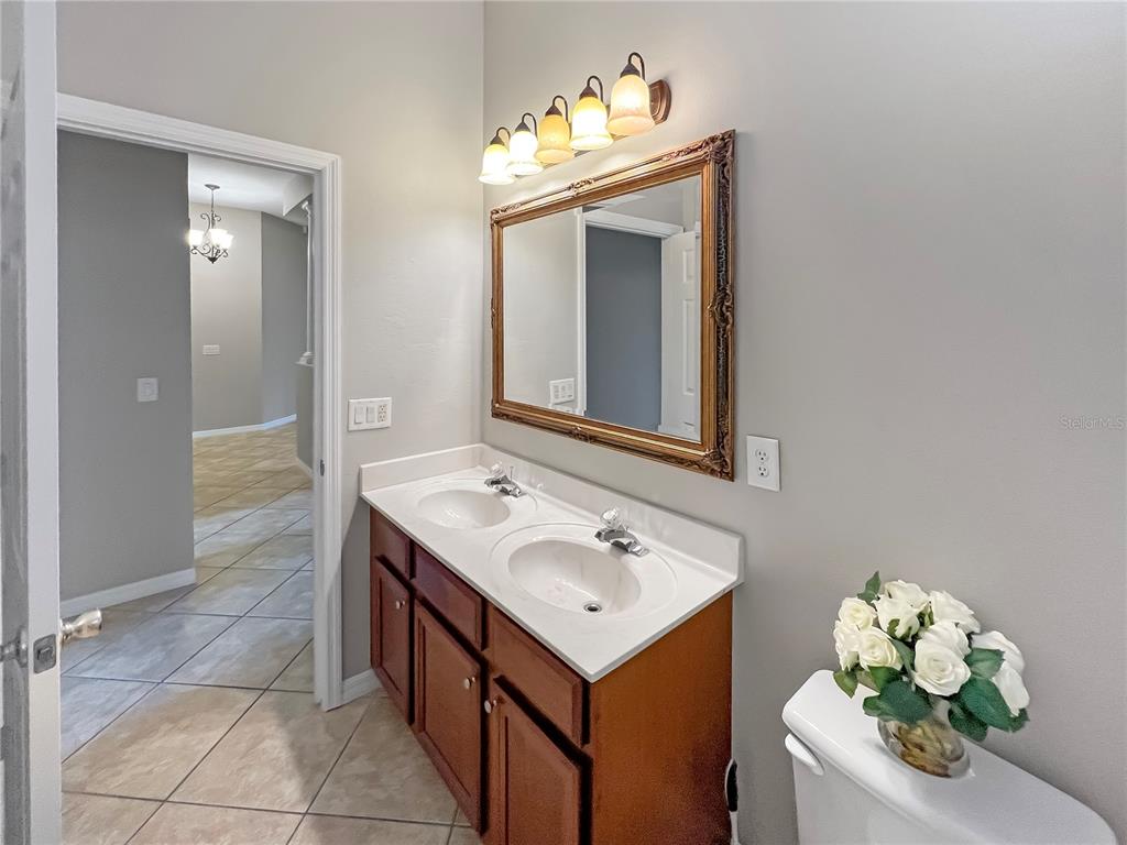 11531 Vicolo Loop Windermere, FL 34786 - Photo 14 of 32 a bathroom with a sink vanity and a mirror