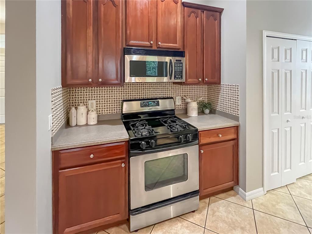 11531 Vicolo Loop Windermere, FL 34786 - Photo 4 of 32 a kitchen with stainless steel appliances granite countertop a stove microwave and sink