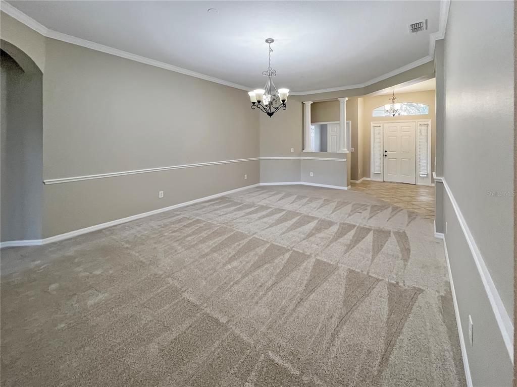 11531 Vicolo Loop Windermere, FL 34786 - Photo 7 of 32 en empty room with windows and chandelier