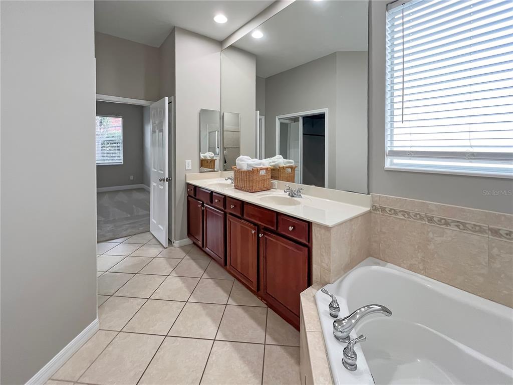 11531 Vicolo Loop Windermere, FL 34786 - Photo 10 of 32 a bathroom with a tub sink and mirror