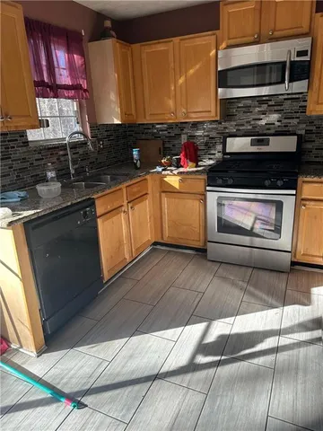 a kitchen with a sink stove and cabinets