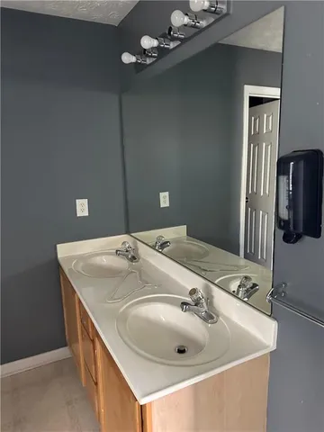 a bathroom with a sink and mirror