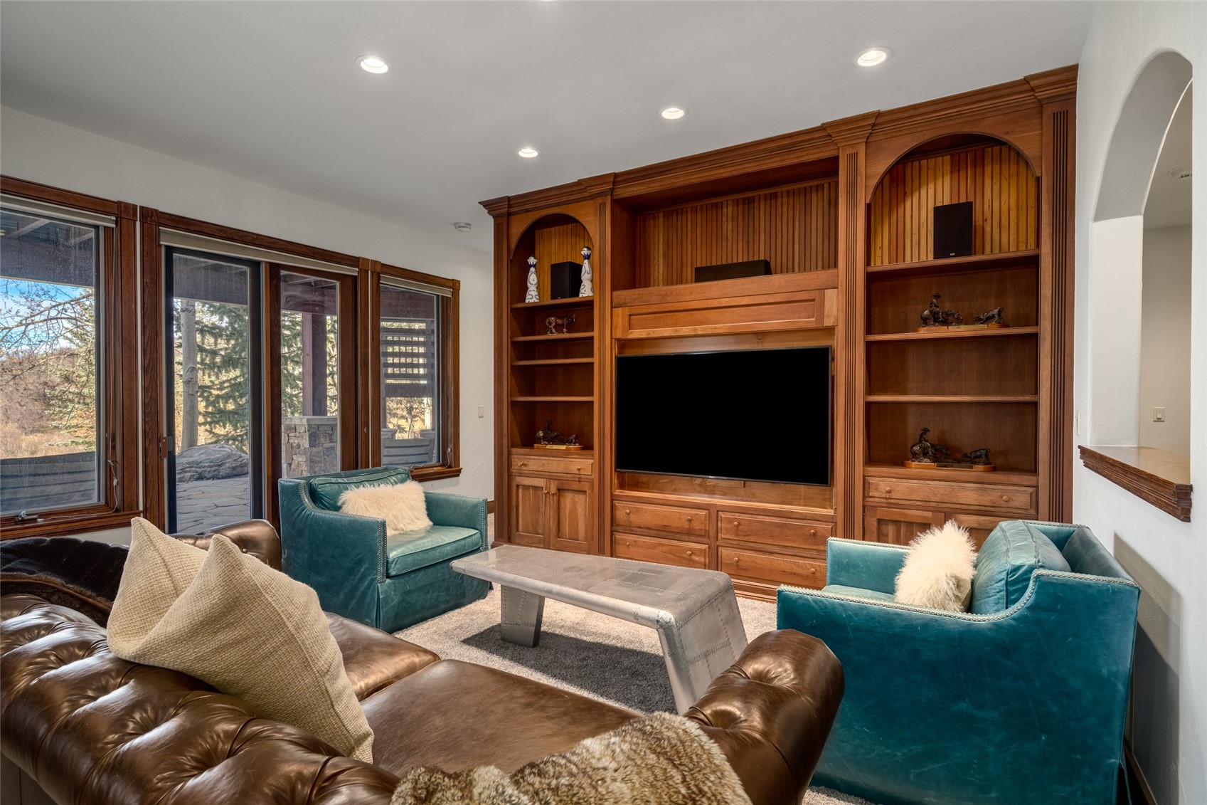 35415 Priest Creek Road Steamboat Springs, CO 80487 - Photo 24 of 50 a living room with furniture floor to ceiling window hardwood floor and a flat screen tv