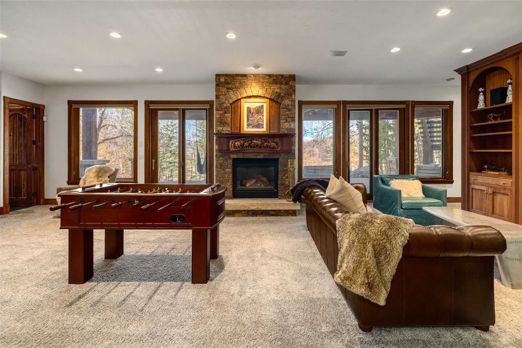35415 Priest Creek Road Steamboat Springs, CO 80487 - Photo 25 of 50 a living room with furniture a fireplace and a floor to ceiling window