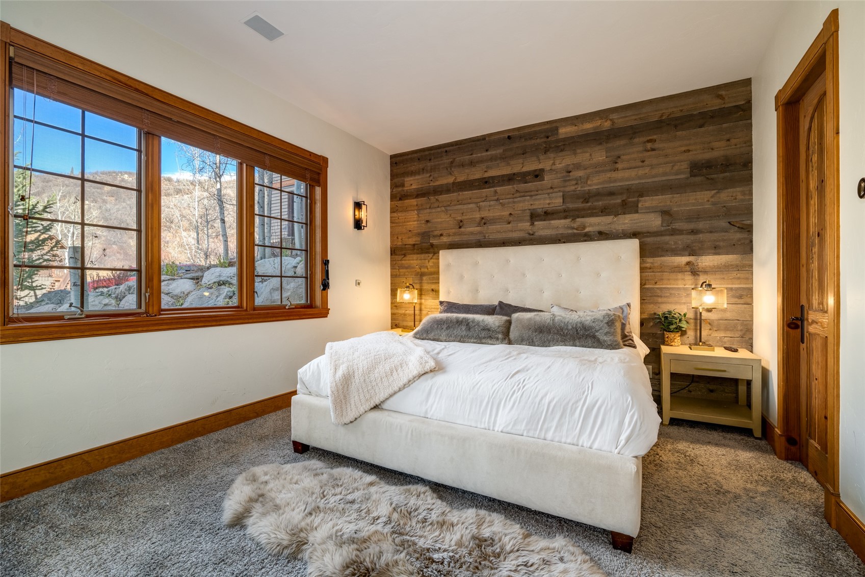 35415 Priest Creek Road Steamboat Springs, CO 80487 - Photo 33 of 50 a bedroom with a large bed and a large window