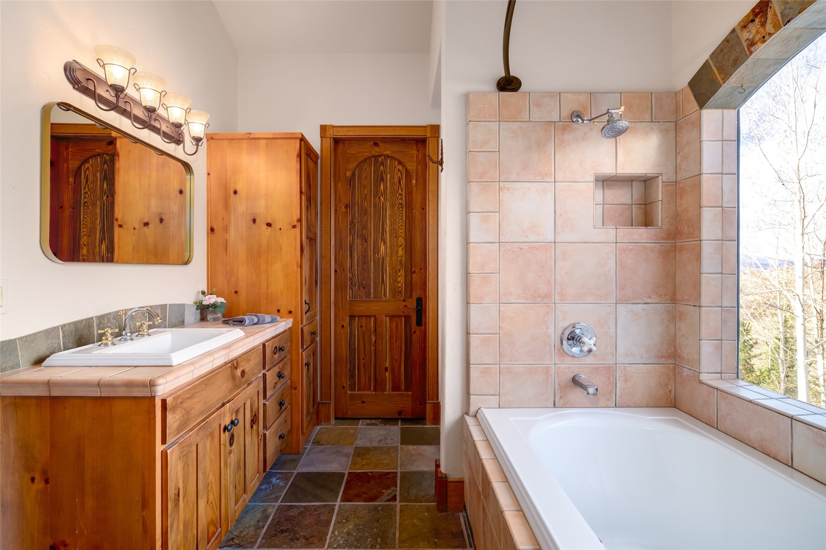 35415 Priest Creek Road Steamboat Springs, CO 80487 - Photo 36 of 50 a bathroom with a tub sink and mirror