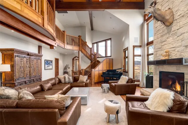 a living room with furniture fireplace and a large window