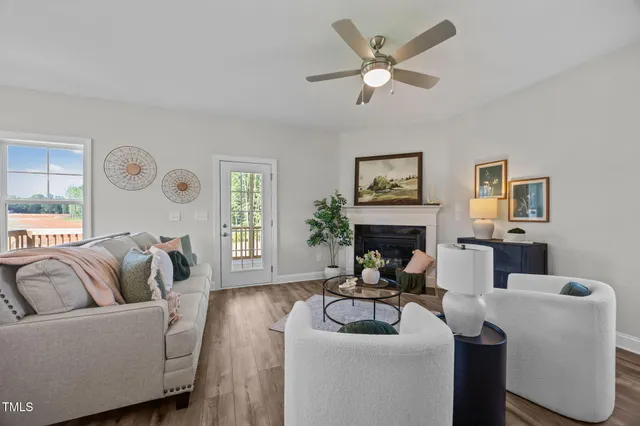 a living room with furniture and a view of kitchen