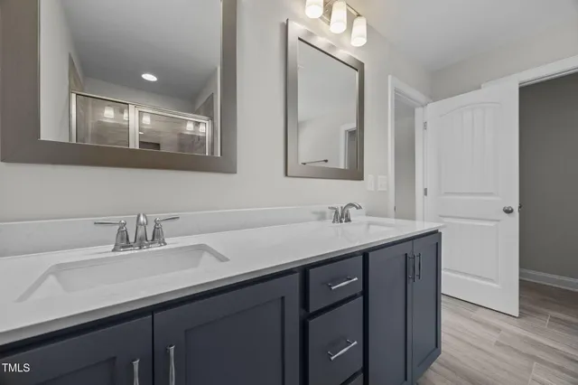 a white bath tub sitting next to a bathroom sink