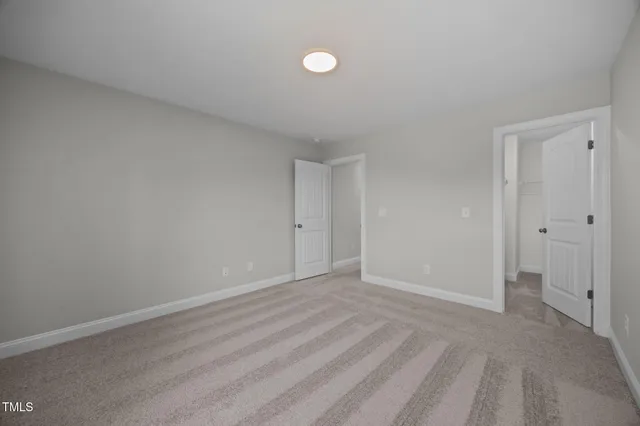 a view of walk in closet with clothes