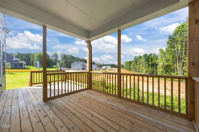 a view of a balcony with wooden floor and fence