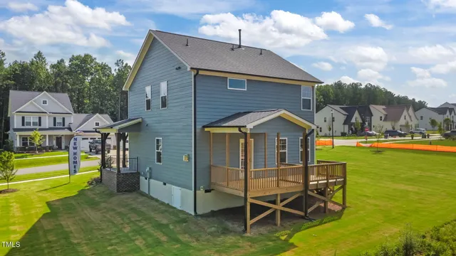 an aerial view of a house with swimming pool and garden