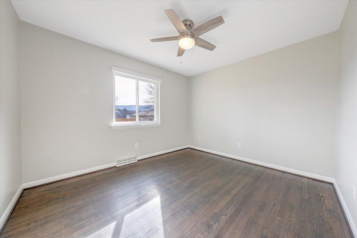 3804 Meadowlark Road Roanoke, VA 24018 - Photo 21 of 54 an empty room with wooden floor and ceiling fan