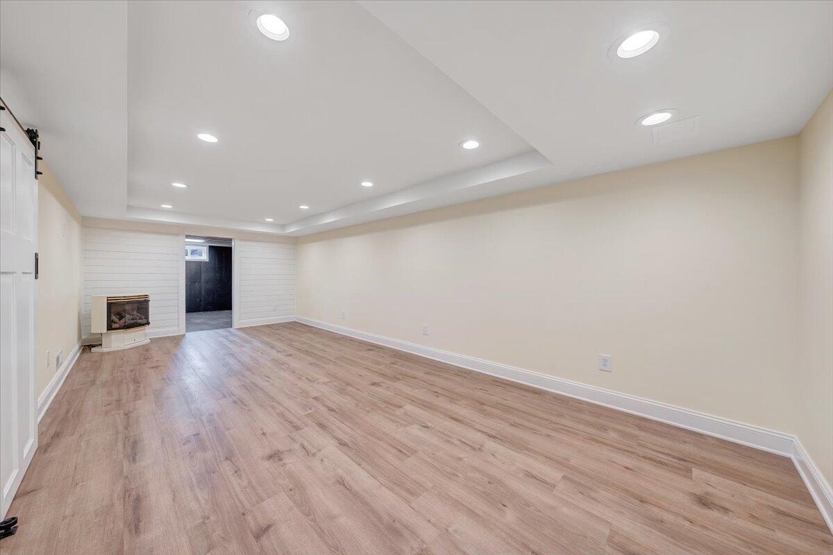 3804 Meadowlark Road Roanoke, VA 24018 - Photo 23 of 54 an empty room with wooden floor and fireplace